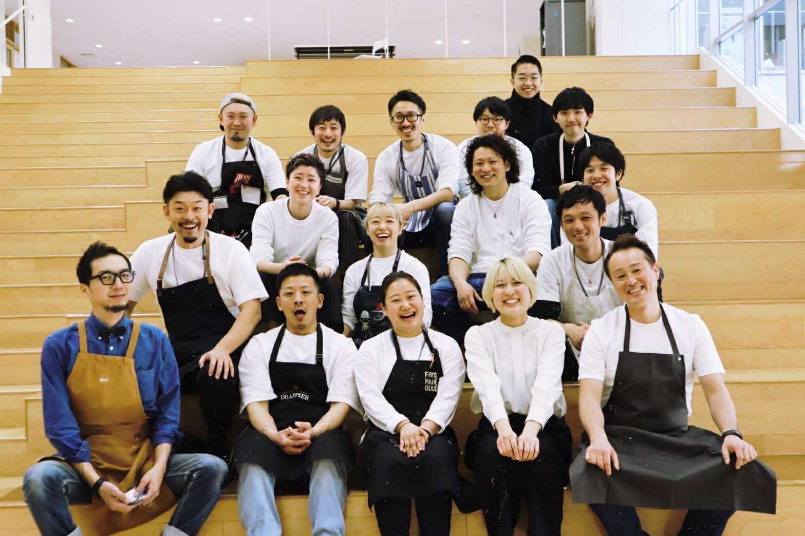 Pizzeria Gtalia Da Filippo employees sitting on steps wearing black aprons