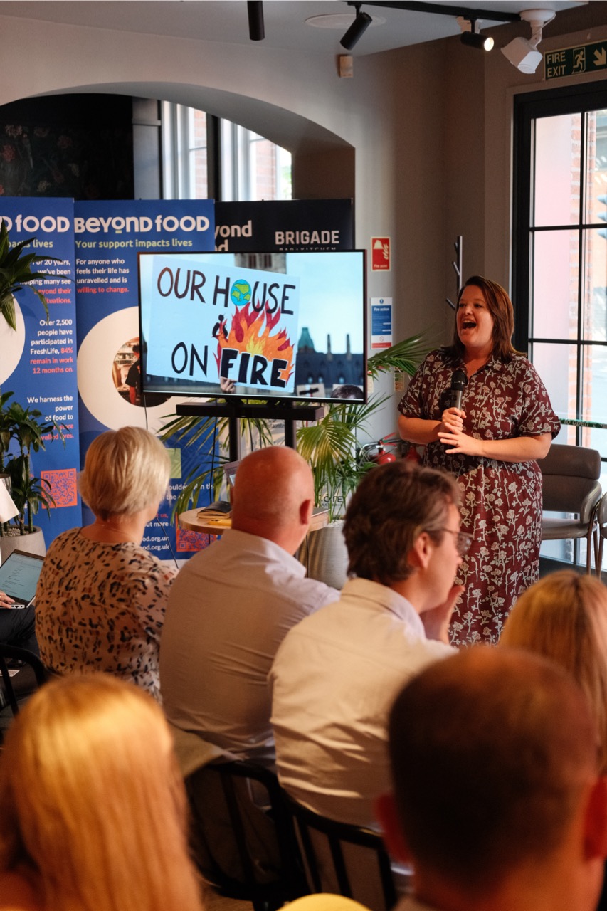 Julaine Caillouette Noble speaking into a microphone at the Rethinking the Menu event