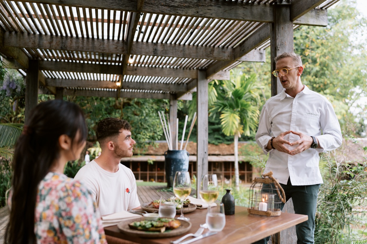Couple being served food outside at the Little Bukit Farm Experience, Rosewood Phuket