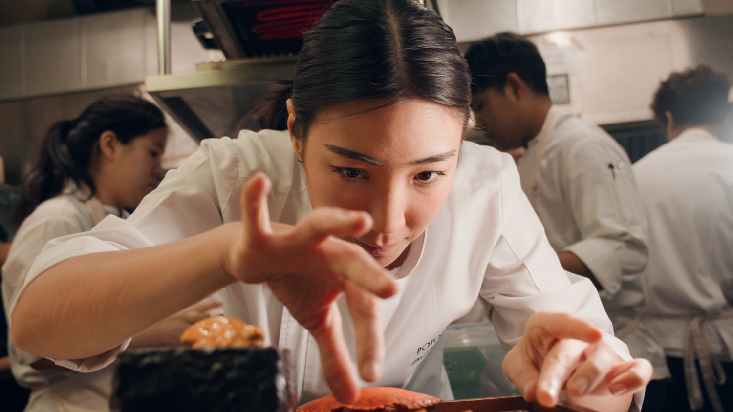 Close up shot of Chef Pam Soontornyanakij plating up food