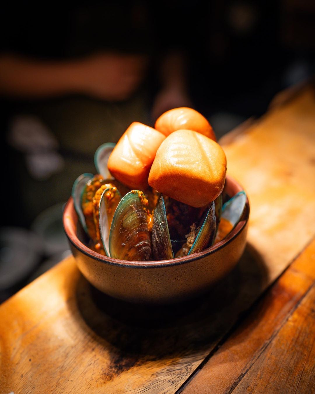 Mussels and chunks of salmon in small bowl