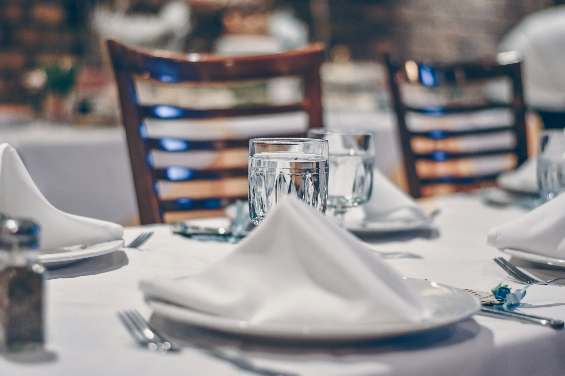 Close up of table set with white lines and glass tumblers
