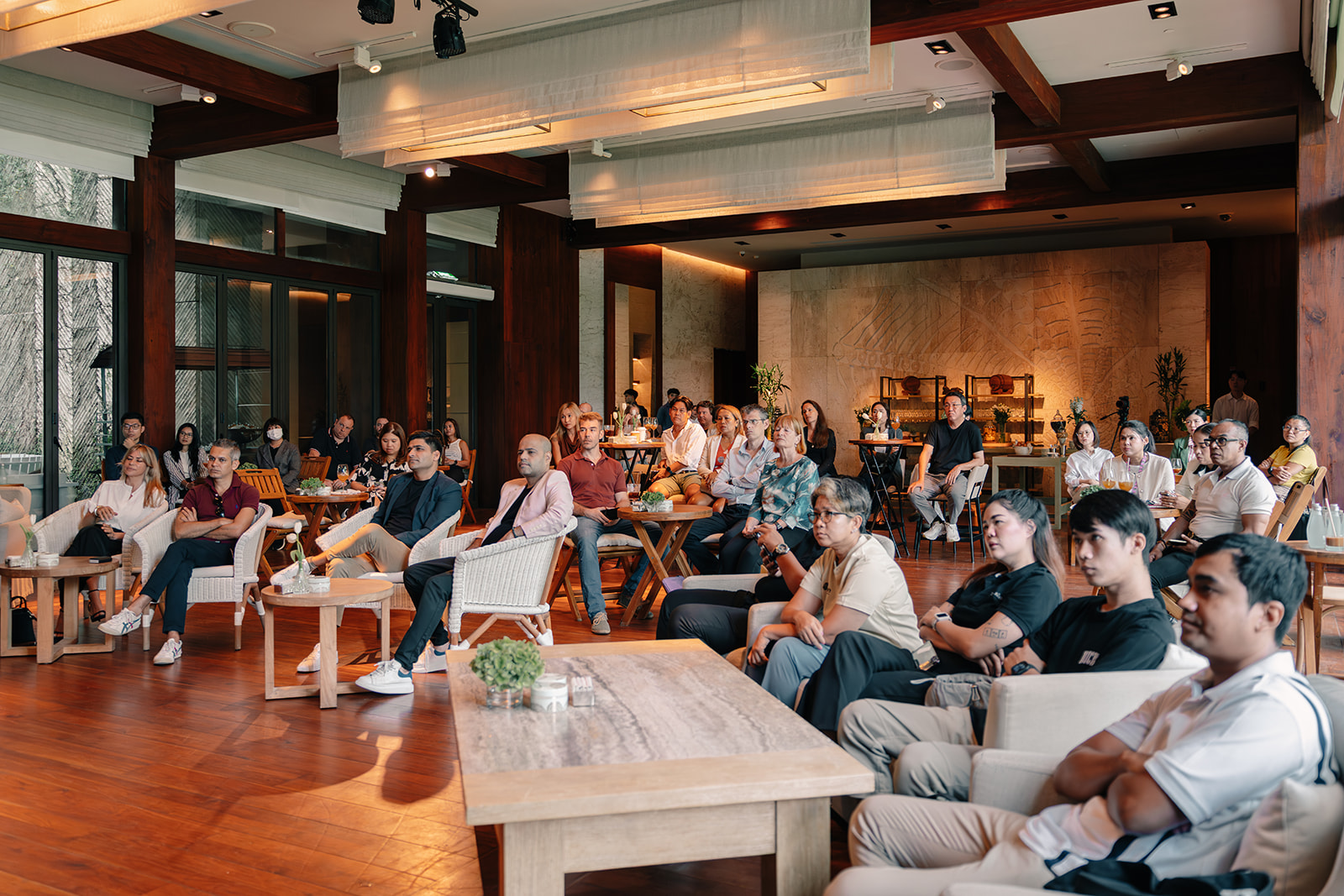 An audience watching a panel discussion at Rosewood Phuket