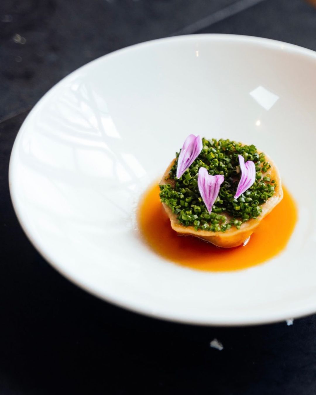 Beautiful food in white bowl on dark surface