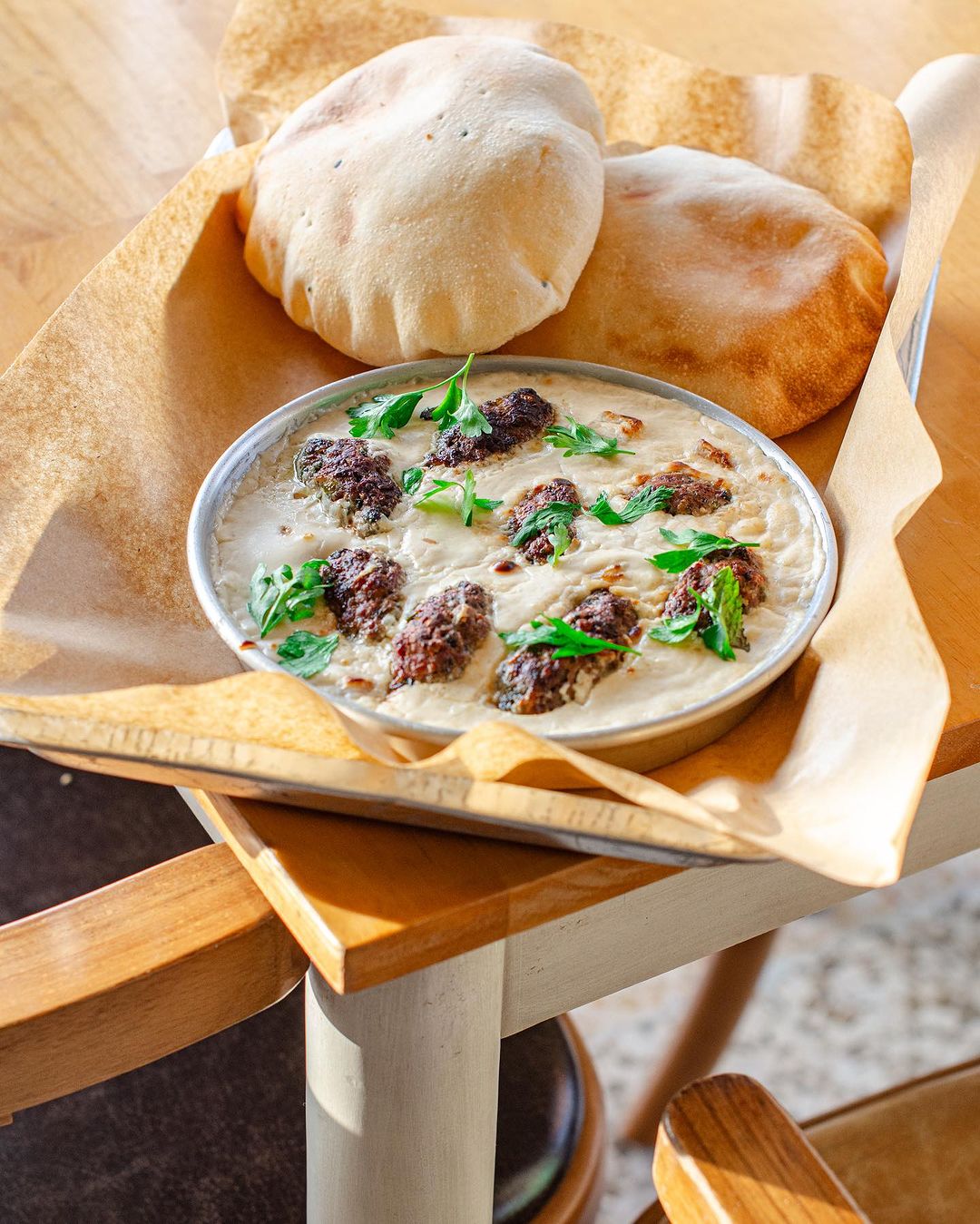 Saucy kofta dish with pittas