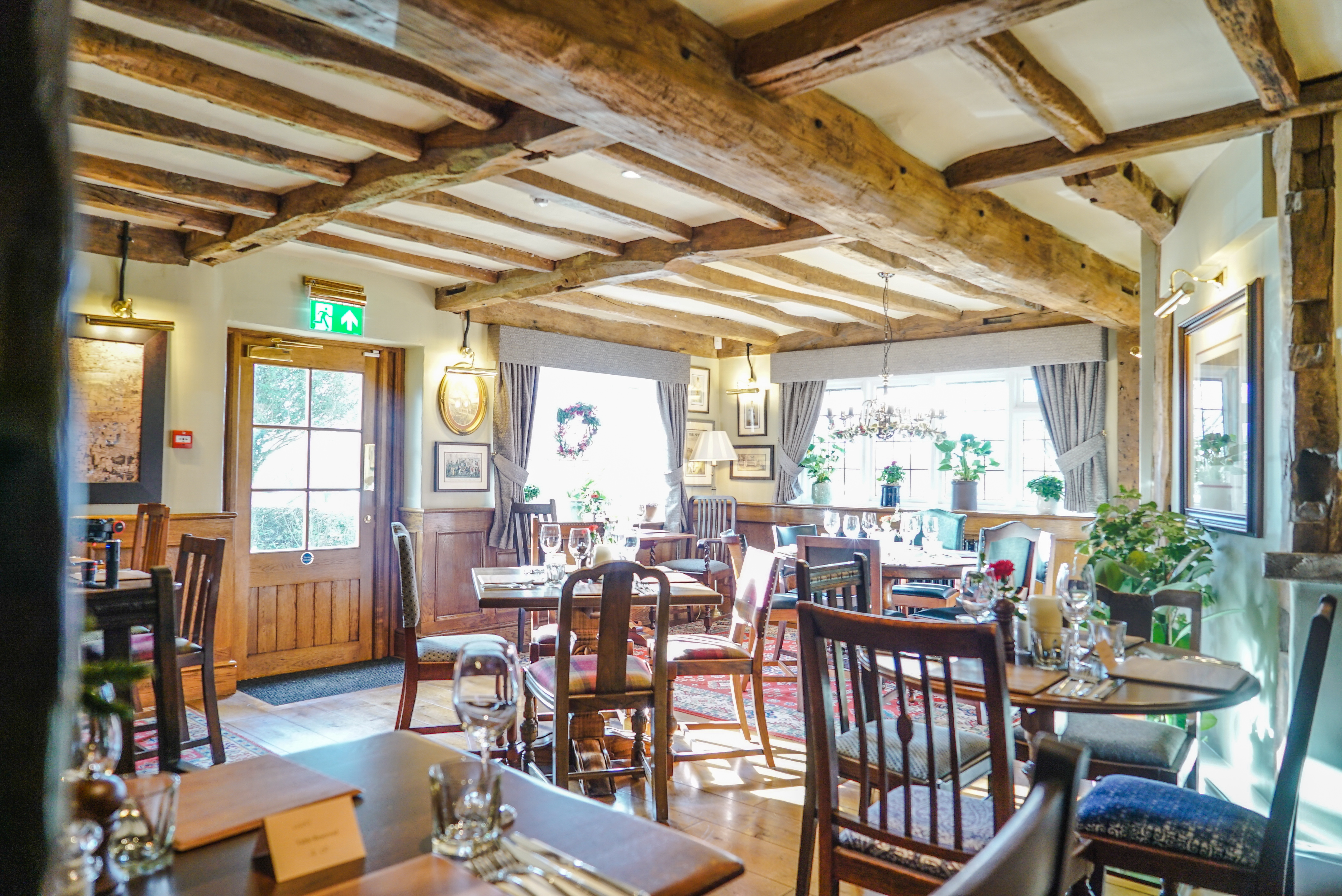 Bright interior shot of a Brunning & Price pub with wooden beams on the ceiling