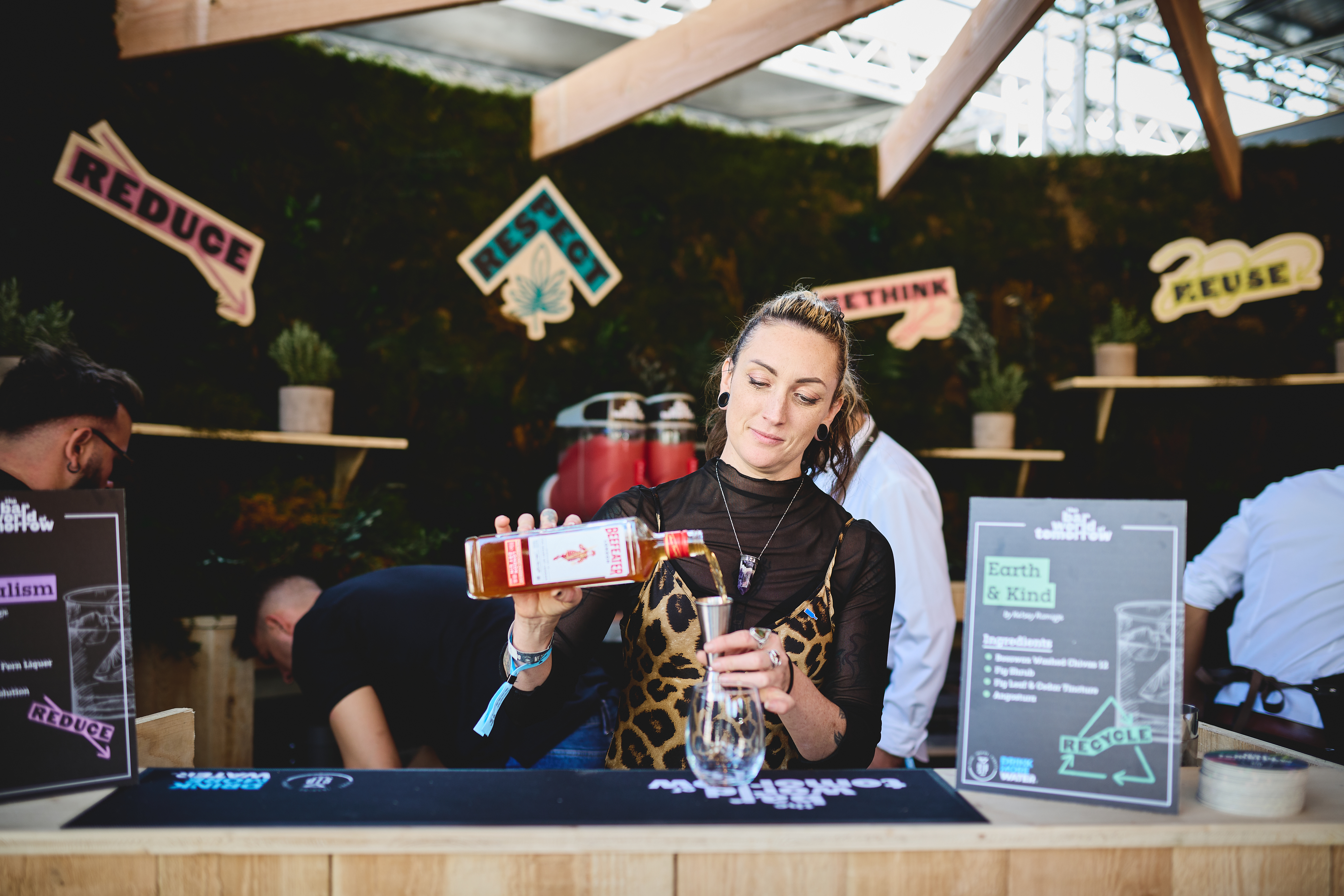 Bartender mixing drinks using Beefeater gin