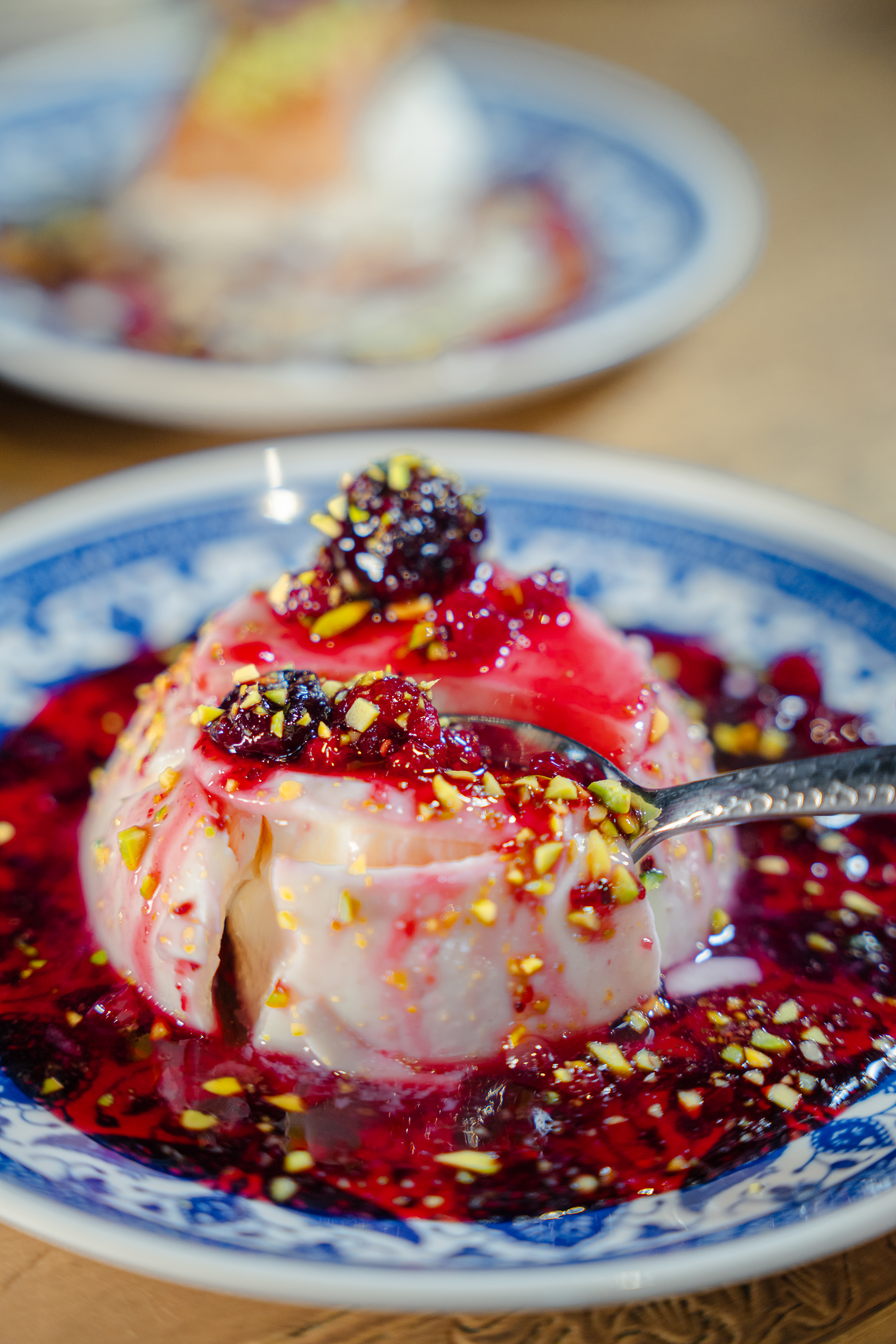 Fork slicing into fruity dessert at Comptoir Libanais