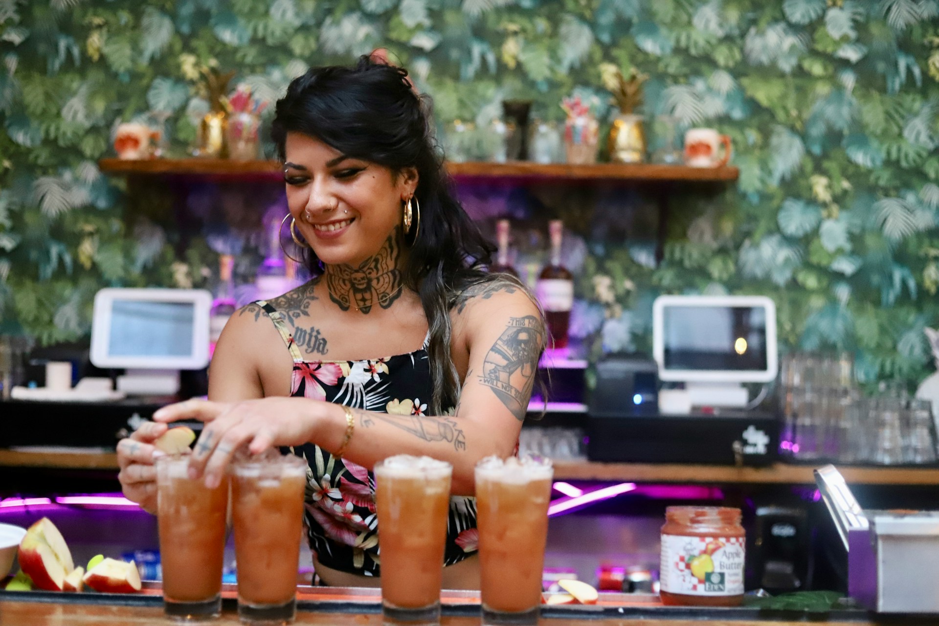Bartender finishing drinks at bar