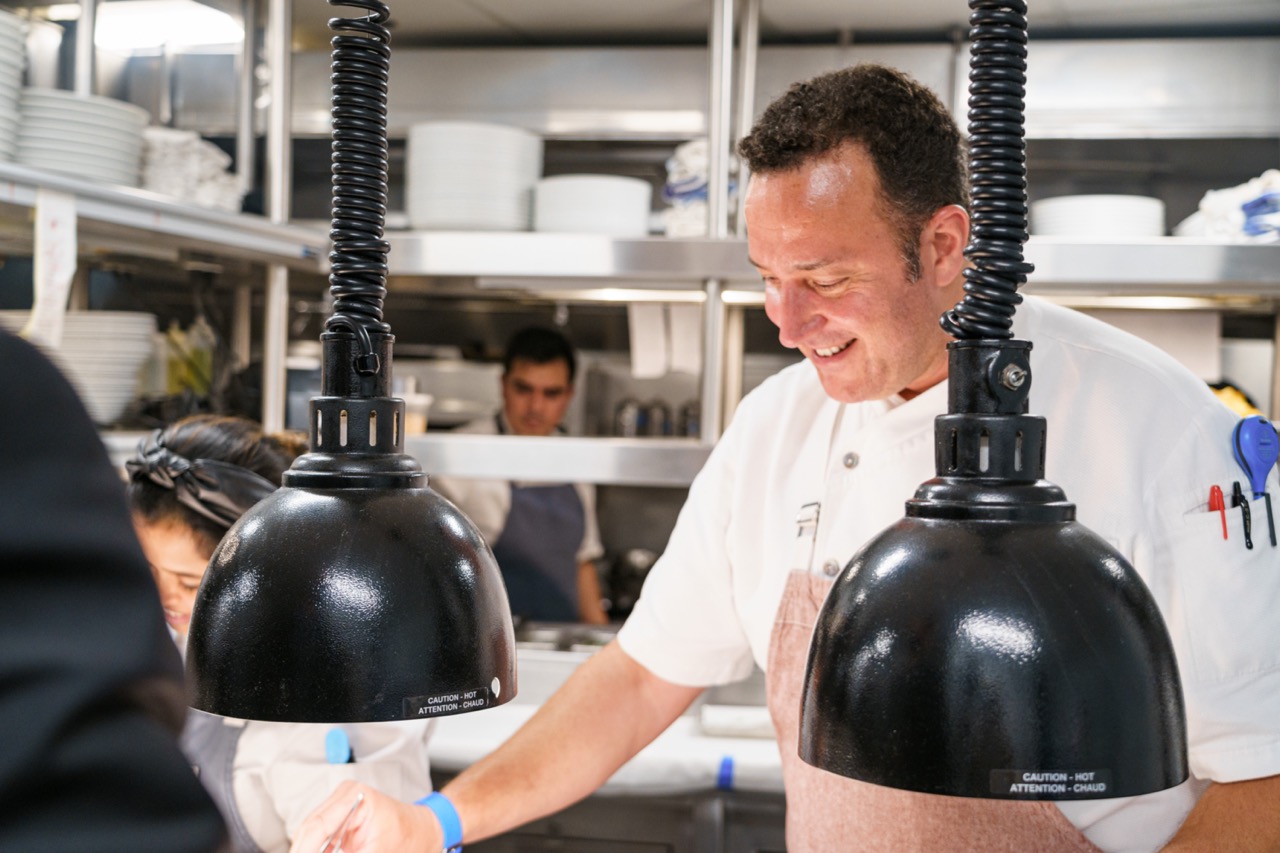 Chef Massimo Falsini working at the pass at Caruso's Rosewood Miramar Beach