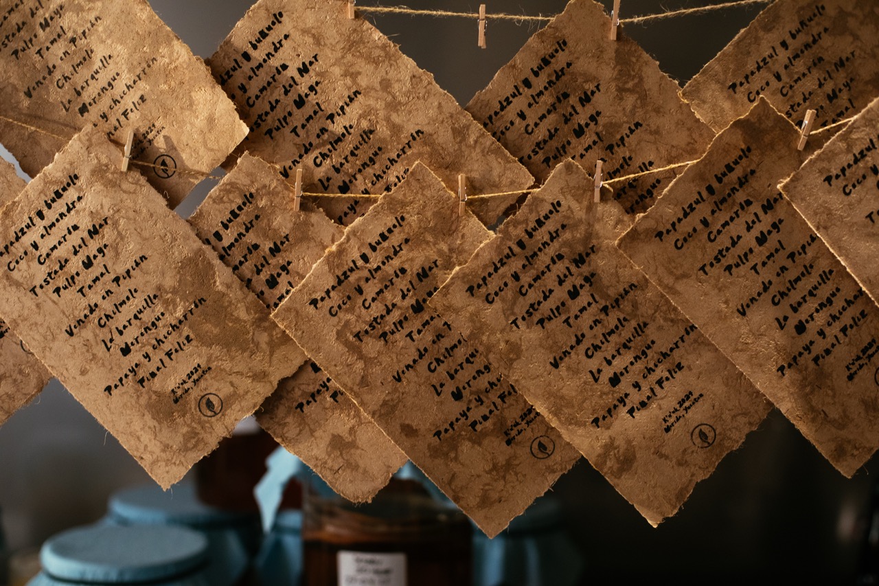Handwritten menus hanging from lines at K'U'UK restaurante