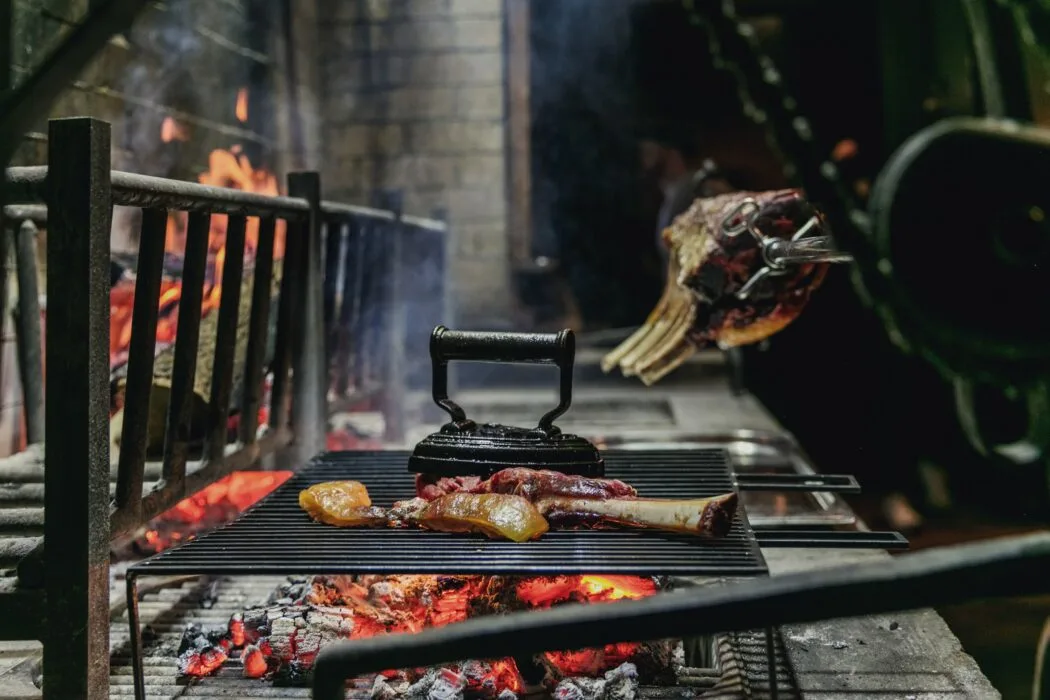 Meat and bones cooking over hot coals