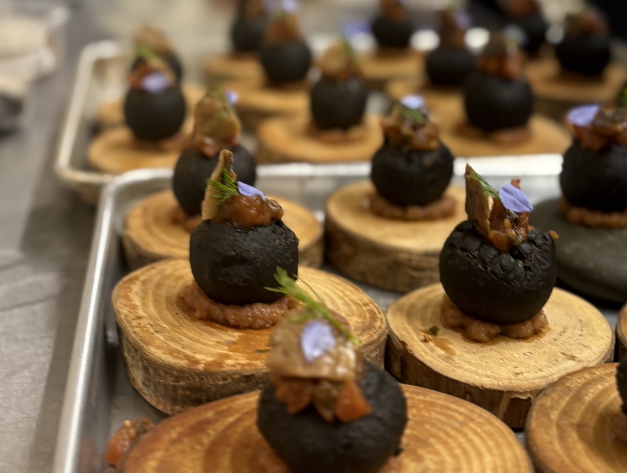 Ready to serve amuse bouches on pieces of wood at Chef's Garden Puerto Rico