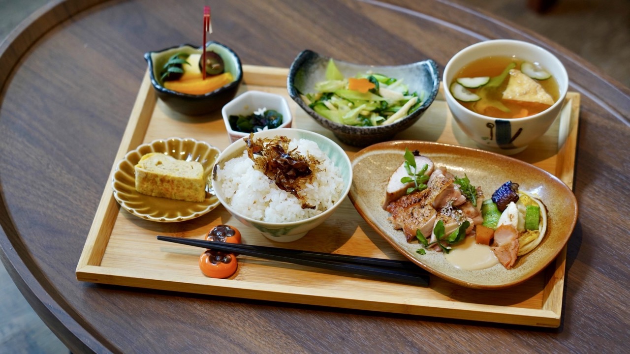 A wooden tray with bowls and plates of beautiful food at Liao Studio, Taiwan