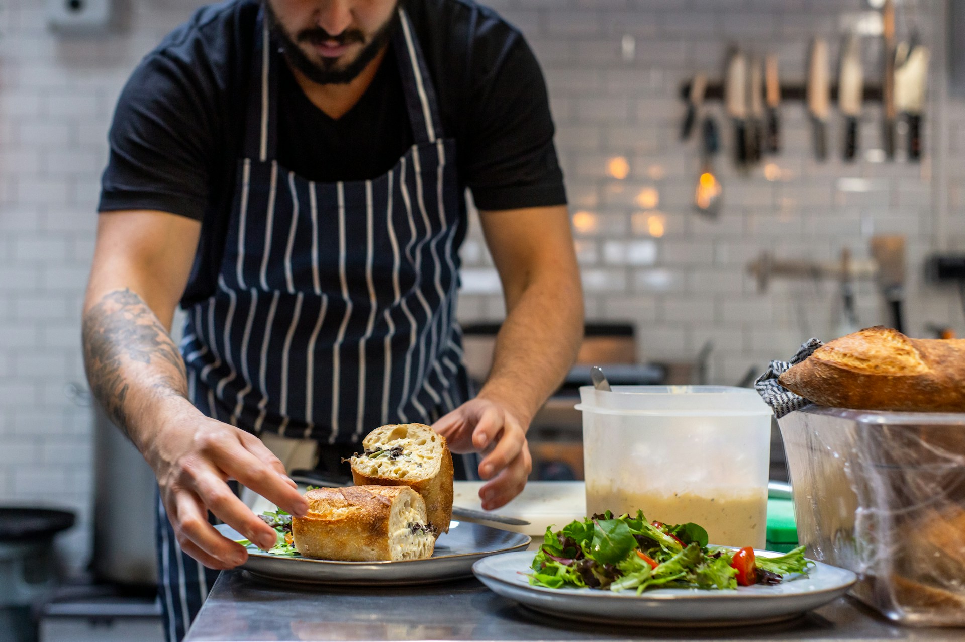 Chef arranging a baguette on a plate