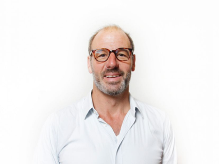 A headshot of Giles Gibbons against a white background