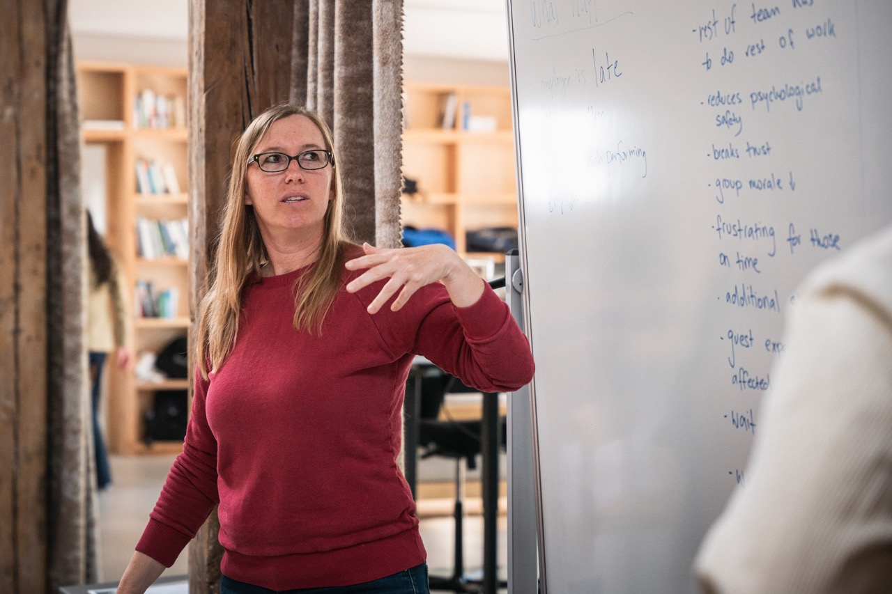 Erin Wade teaching at MAD Academy, gesturing to whiteboard