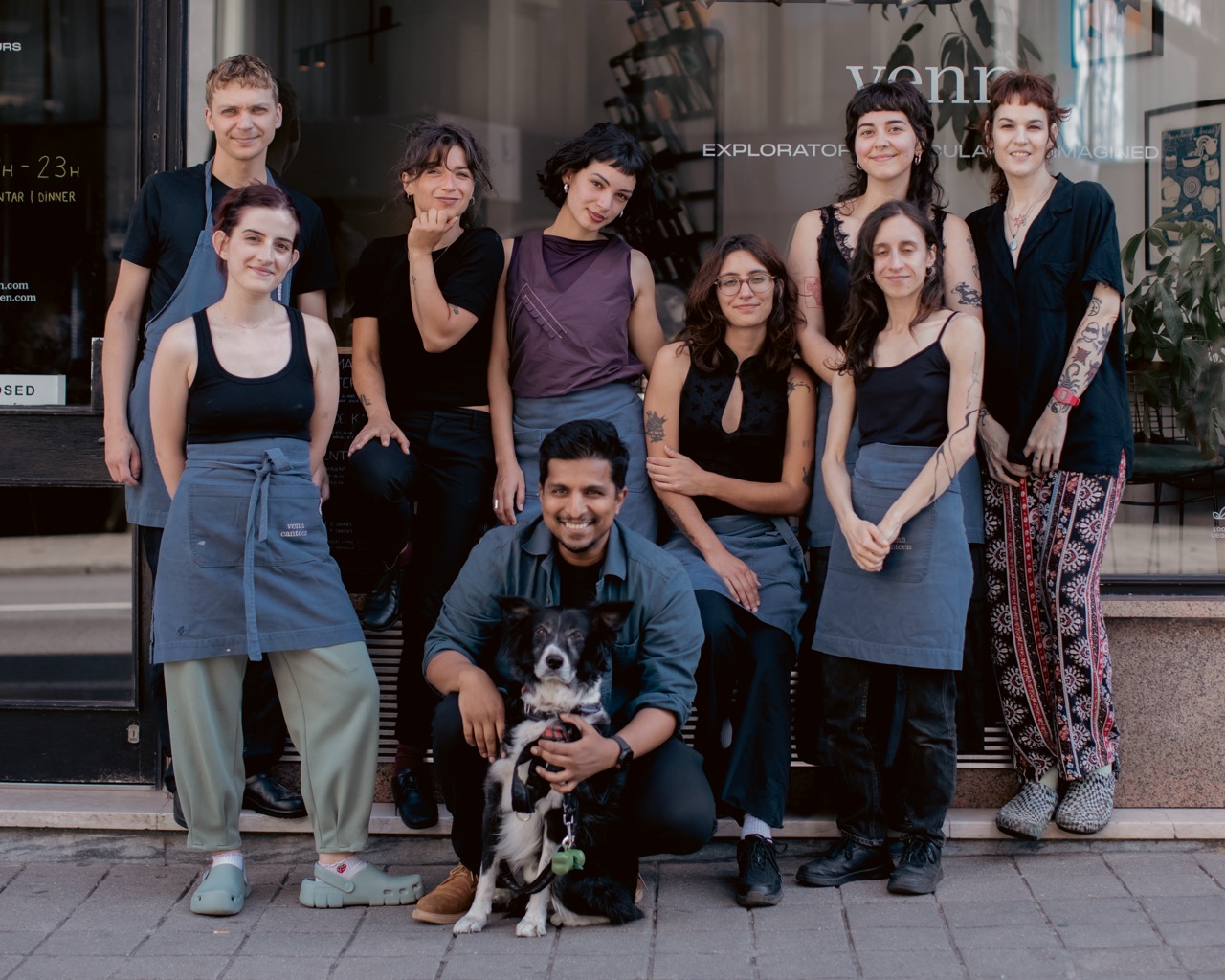 The full team at venn canteen posing outside with a dog