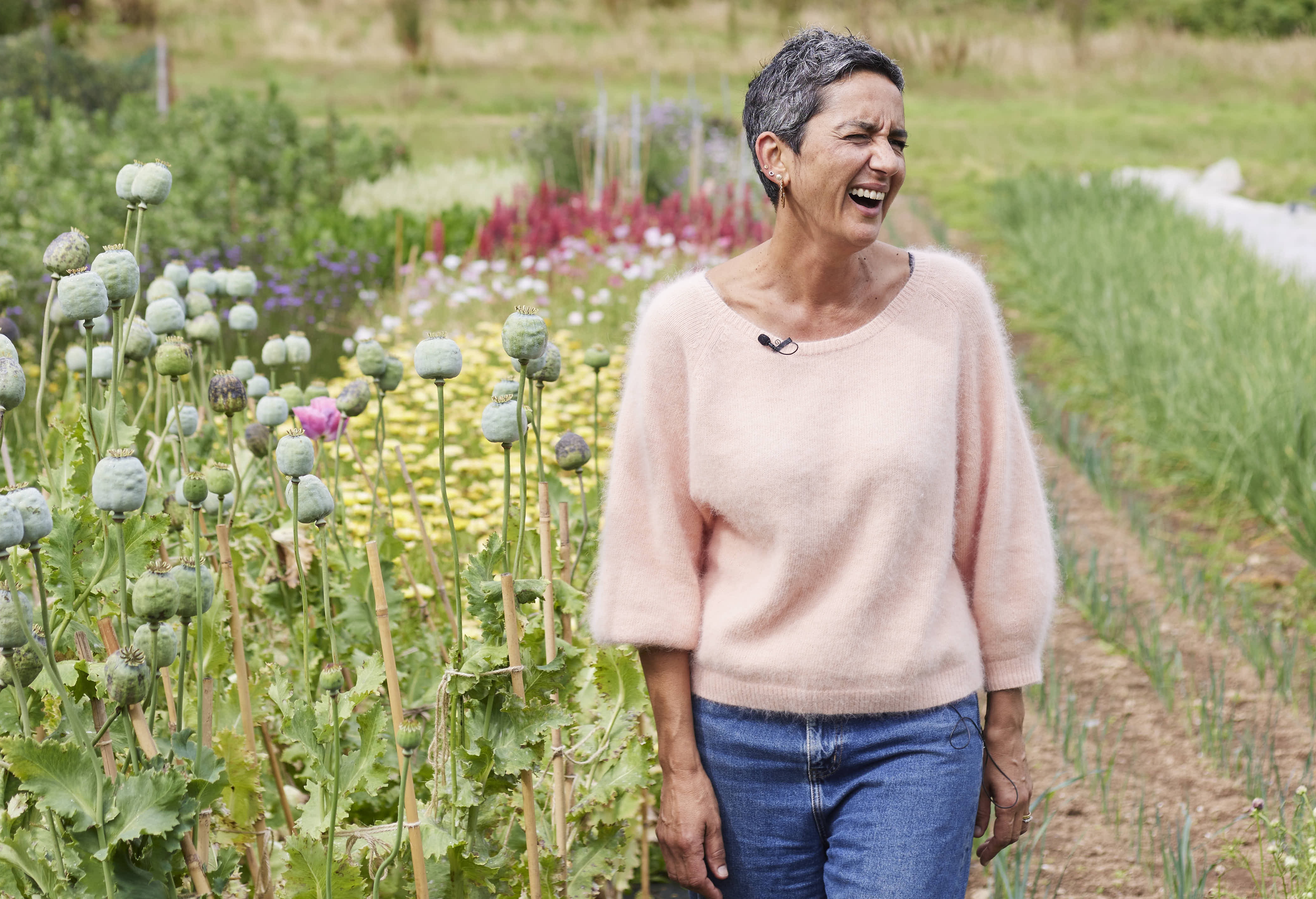 Geetie Singh Watson, owner of The Bull Inn in Totnes, standing in a field and laughing