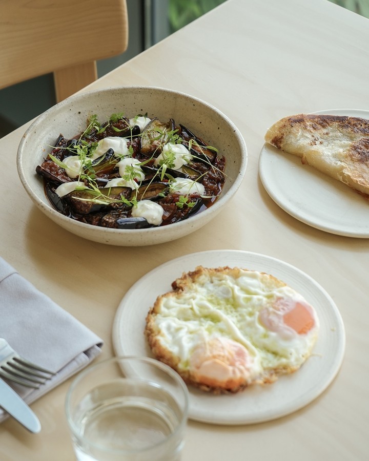 Aubergine dish and fried eggs 