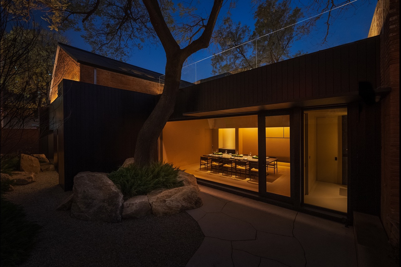The exterior of Lamdre, Beijing, in the evening time, with the inside lit with warm light