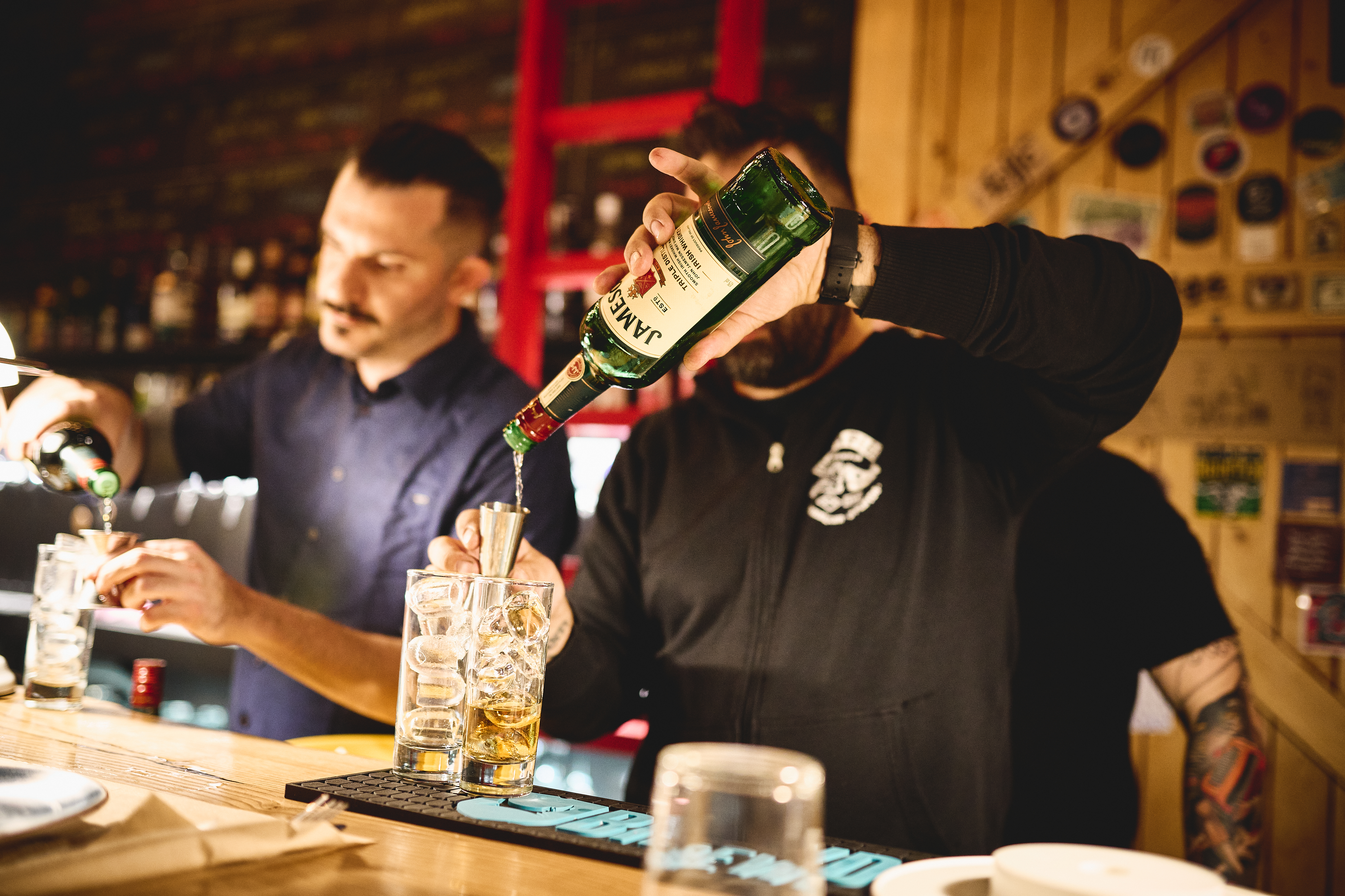 Bartenders mixing drinks using Jameson Irish whiskey