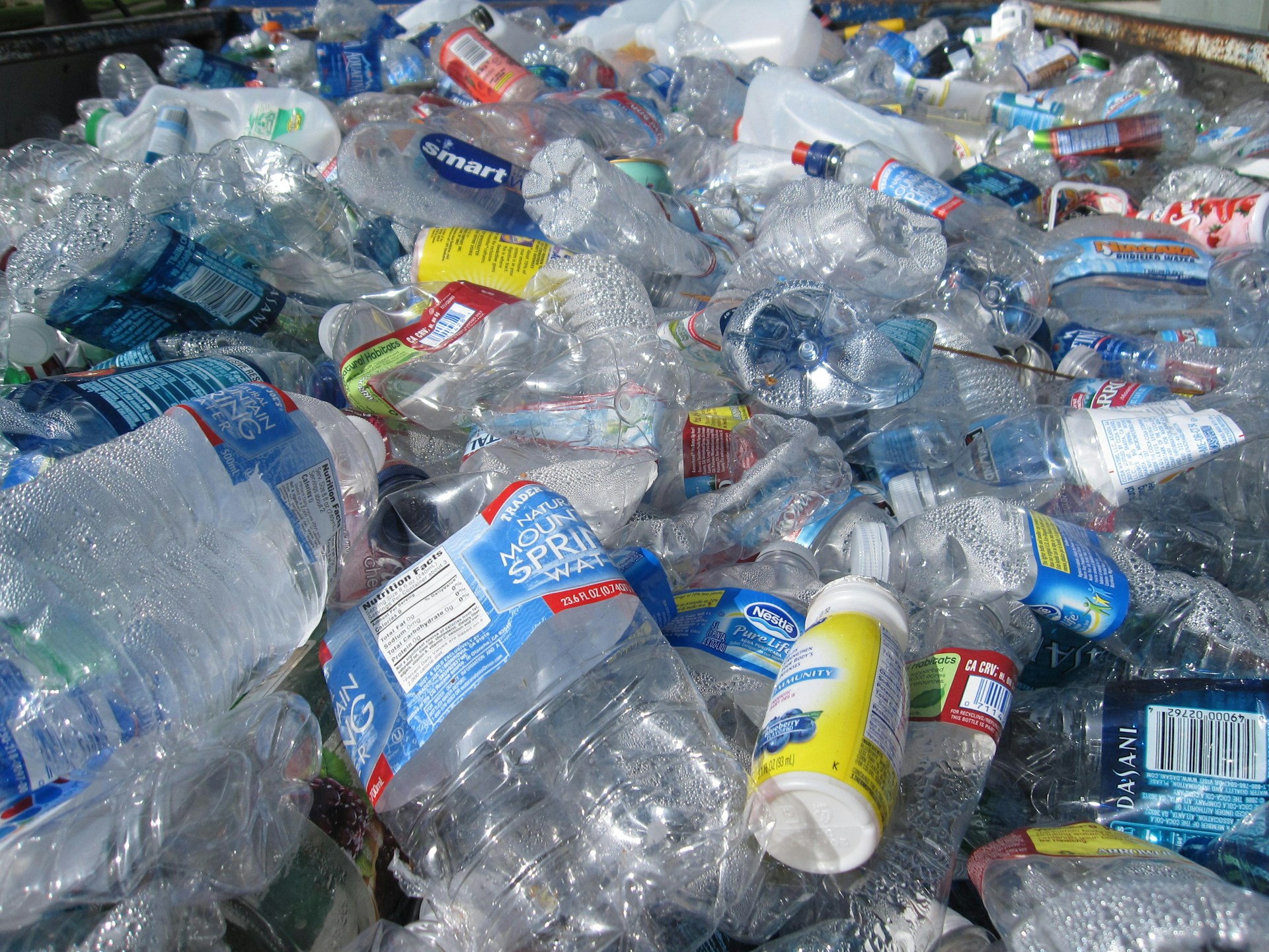 Close up of lots of plastic bottles and other plastic rubbish