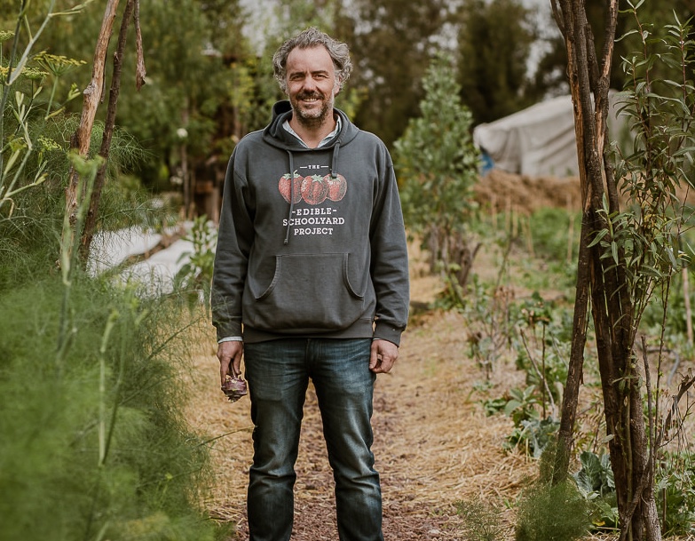 Founder of Arca Tierra Lucio Usobiaga standing in vegetable garden
