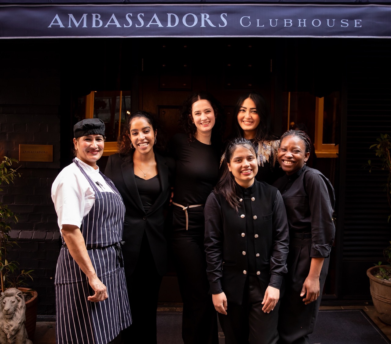 Some of the Ambassadors Clubhouse team outside the restaurant in their uniforms