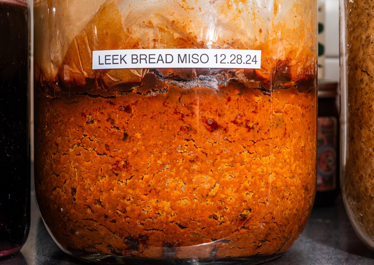 A labelled glass jar containing leek bread miso at Oyster Oyster, Washington DC