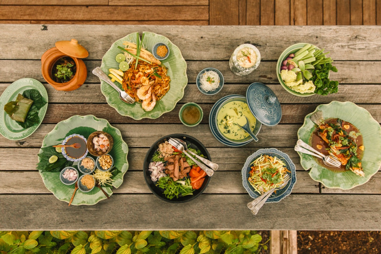 Overhead shot of healthy dishes on wooden table at Rosewood Hotel Phuket