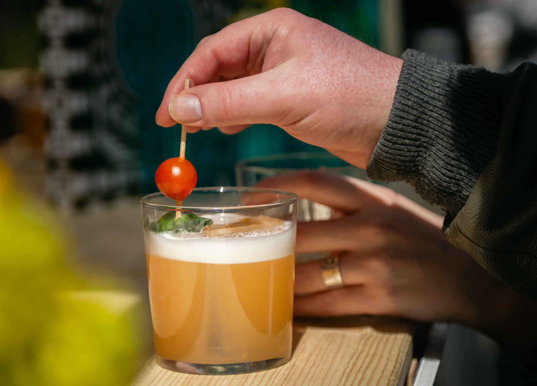 Hand adding garnish to cocktail at Paradiso Sustainability Summit