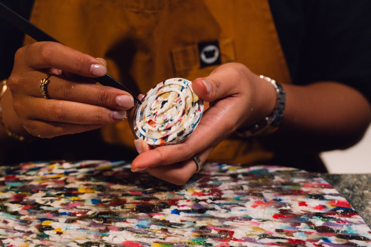 Waste Lab at Potato Head Bali making lids for water bottles out of Styrofoam and plastic