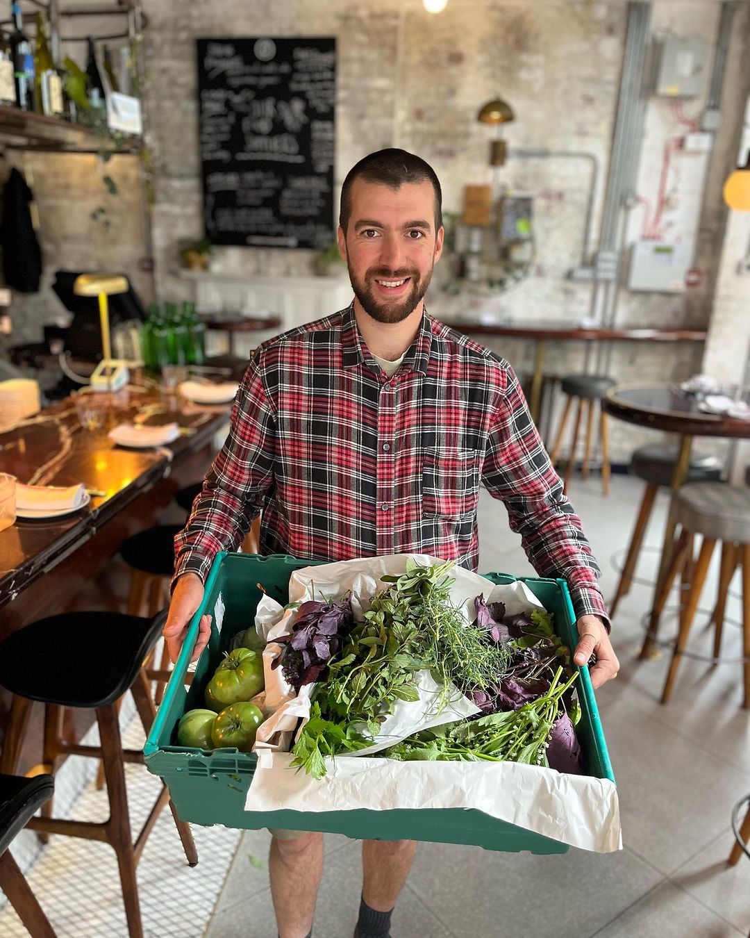 Man holding box of vegetables in THE BUXTON London