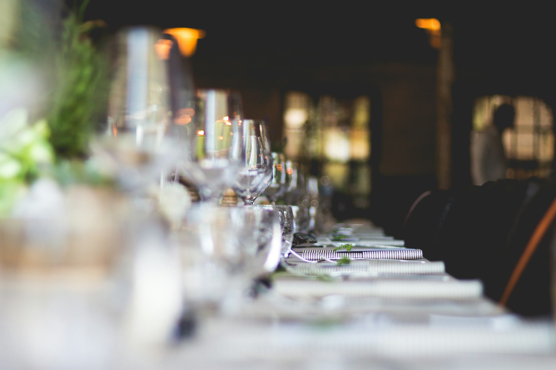 Low-angle shot of restaurant table set with glasses and cutlery