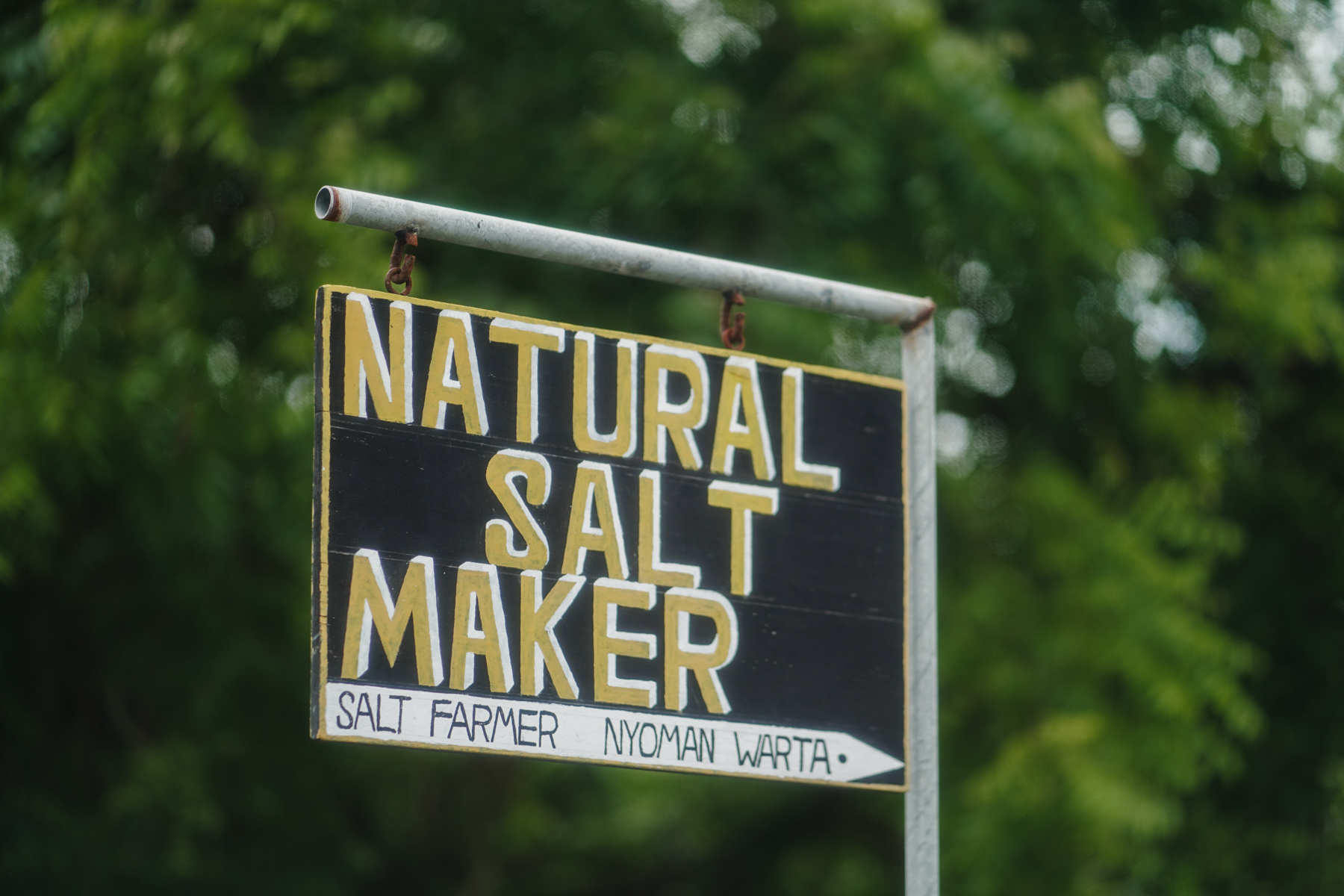 Sign saying 'Natural Salt Maker. Salt farmer Nyoman Warta'