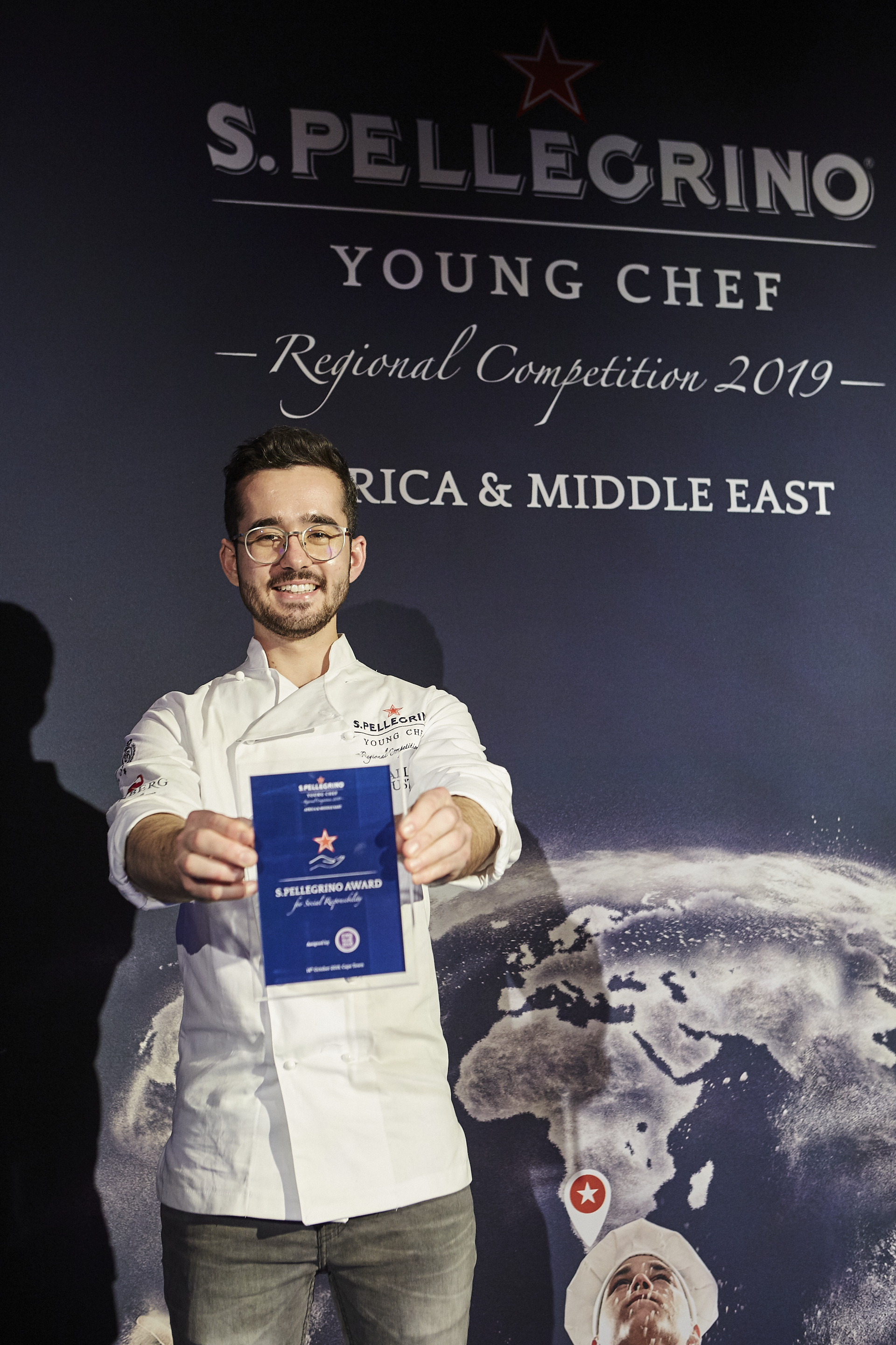 Callan Austin showing off his award for Social Responsibility at the S.Pellegrino Young Chef Academy Awards