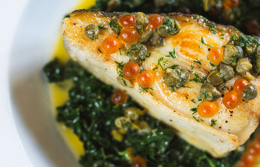 Beautiful fish dish at Peach Pubs with capers, roe and dark leafy greens