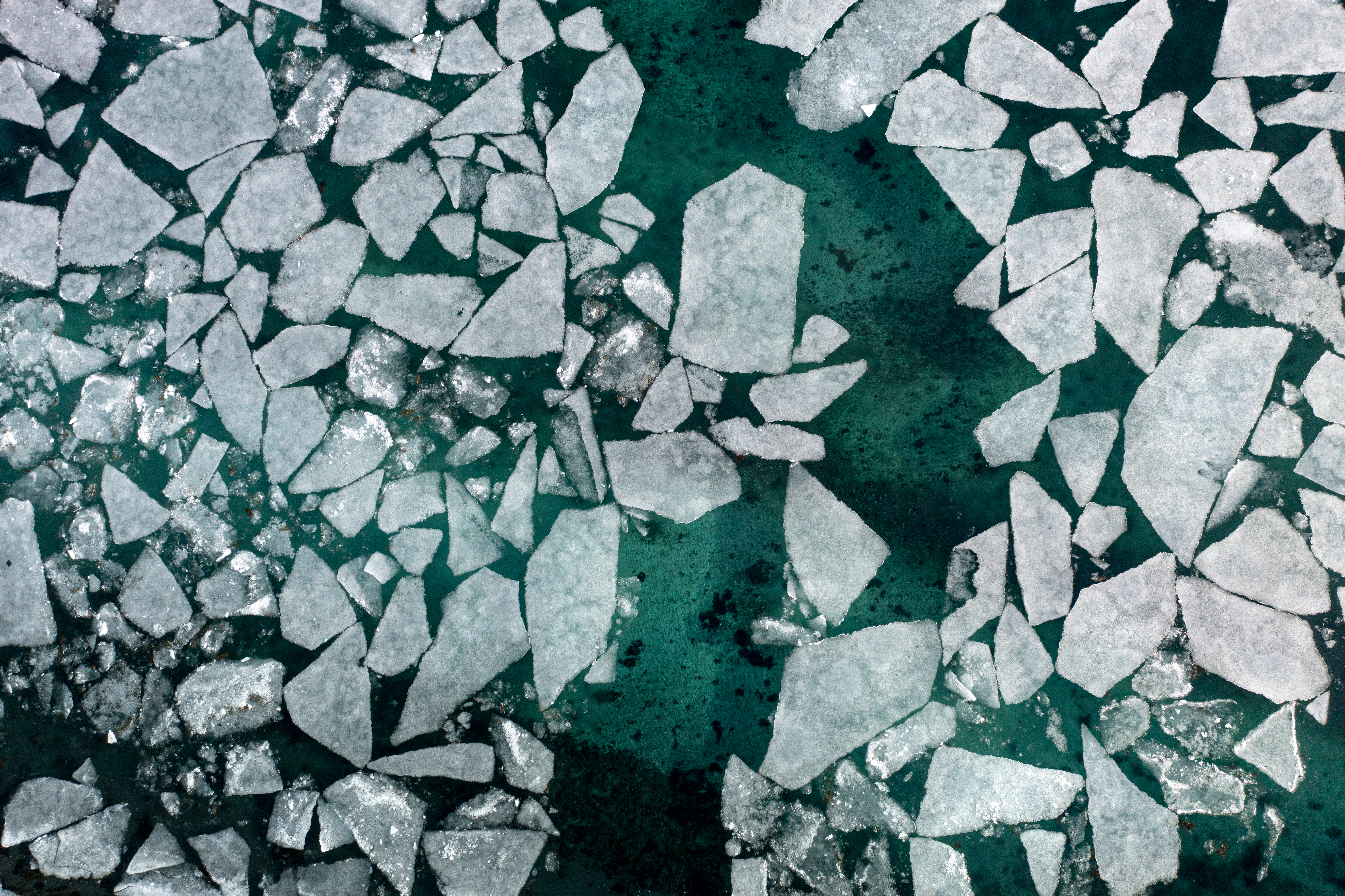 Shards of salt in blue-green water, shot from overhead