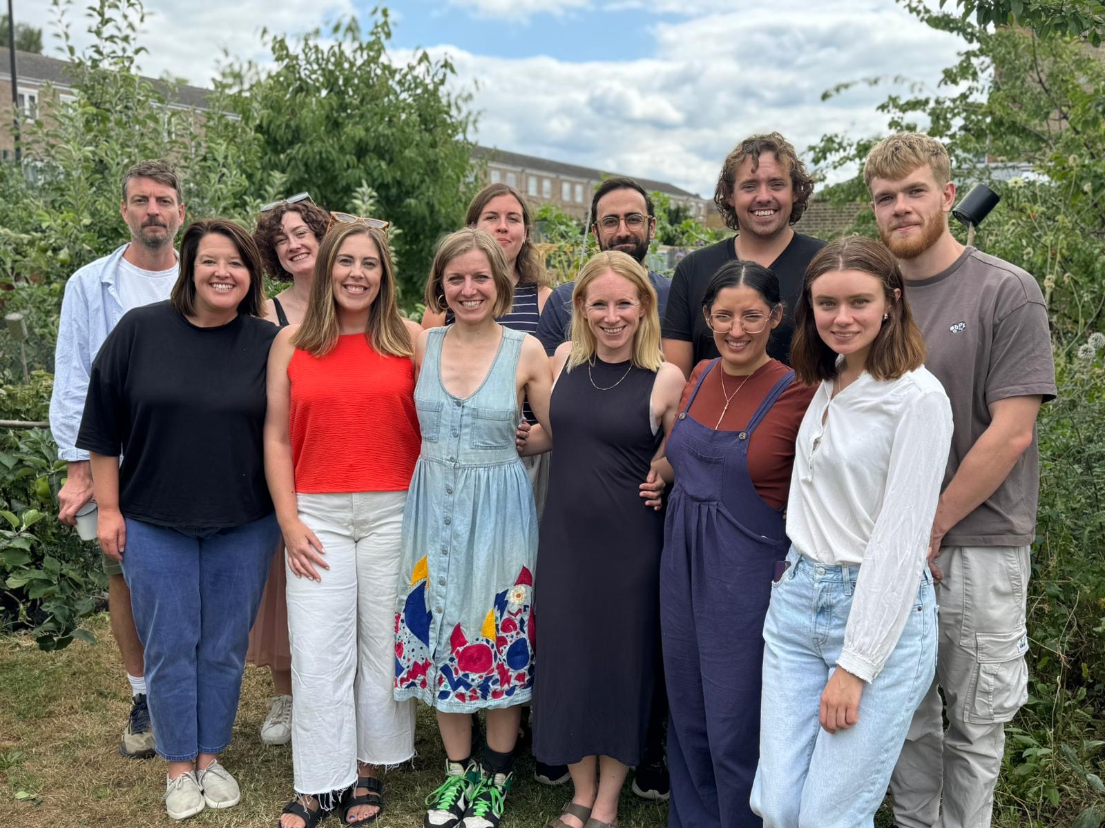 The whole team at The Sustainable Restaurant Association in summer 2025, standing in a garden