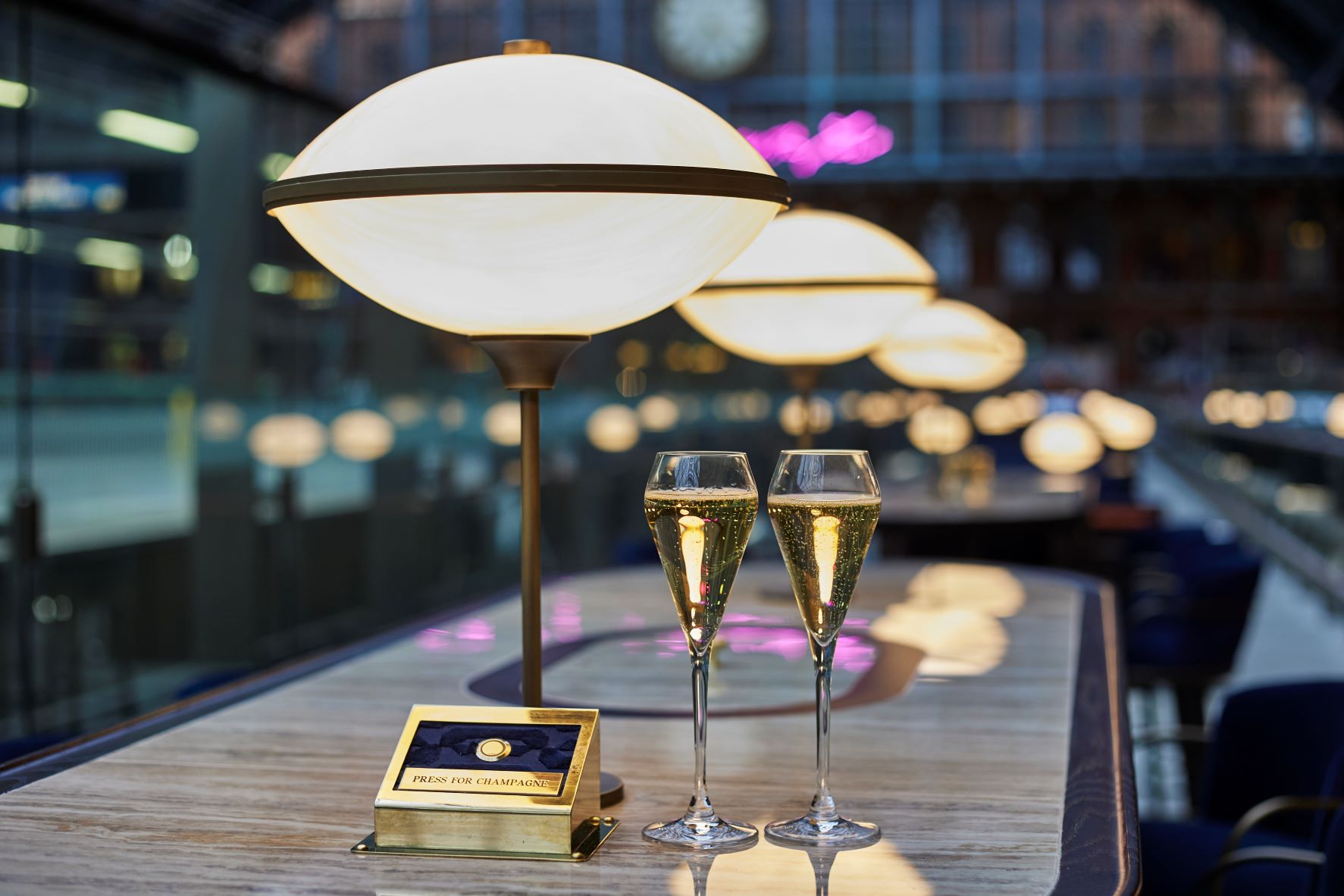 Two flutes of sparkling wine on the bar at Searcys