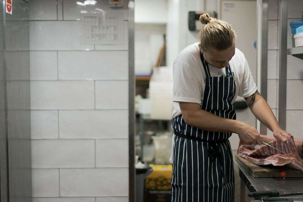 A chef doing butchery at The Bull Inn, Totnes
