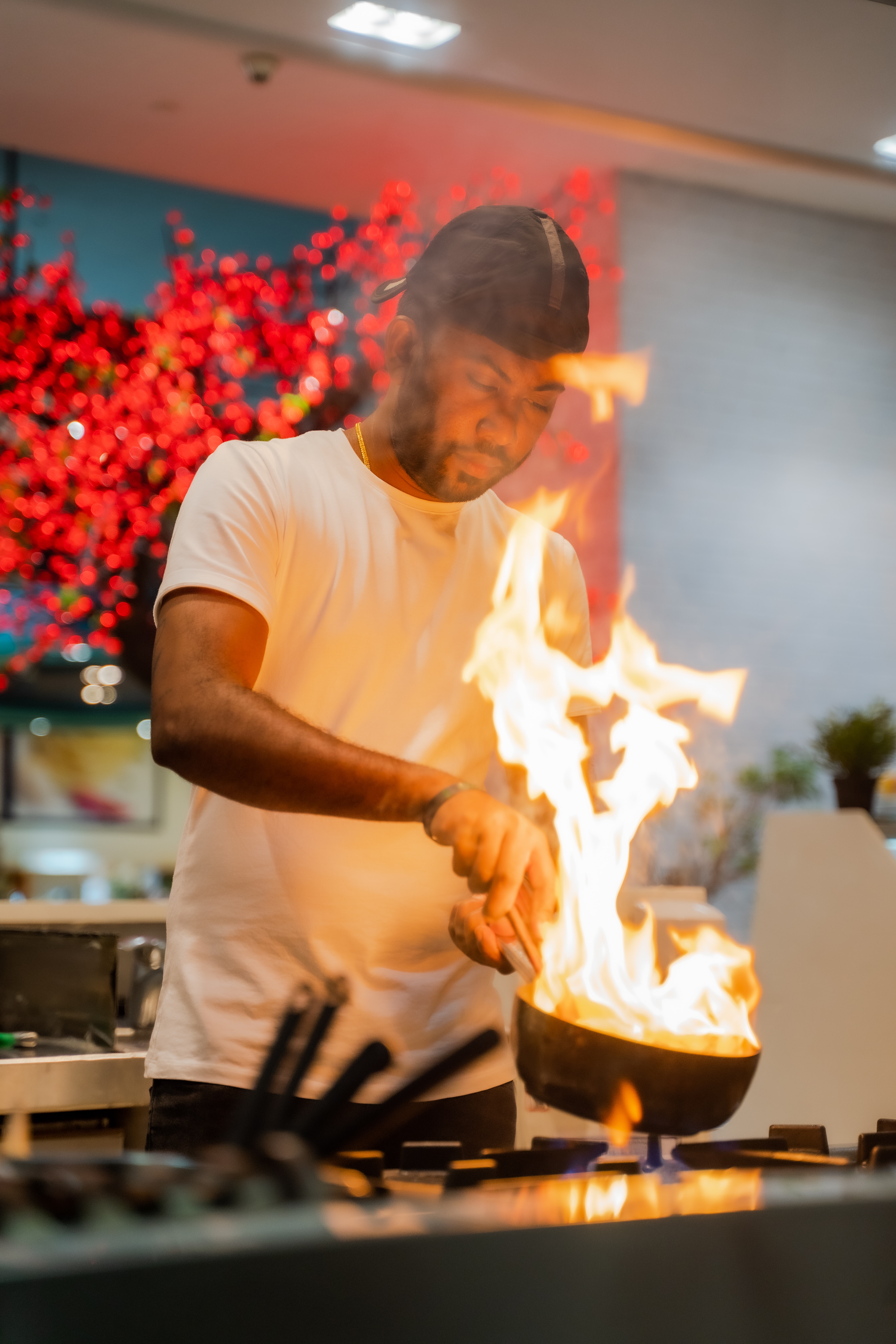 Chef cooking in pan with flames