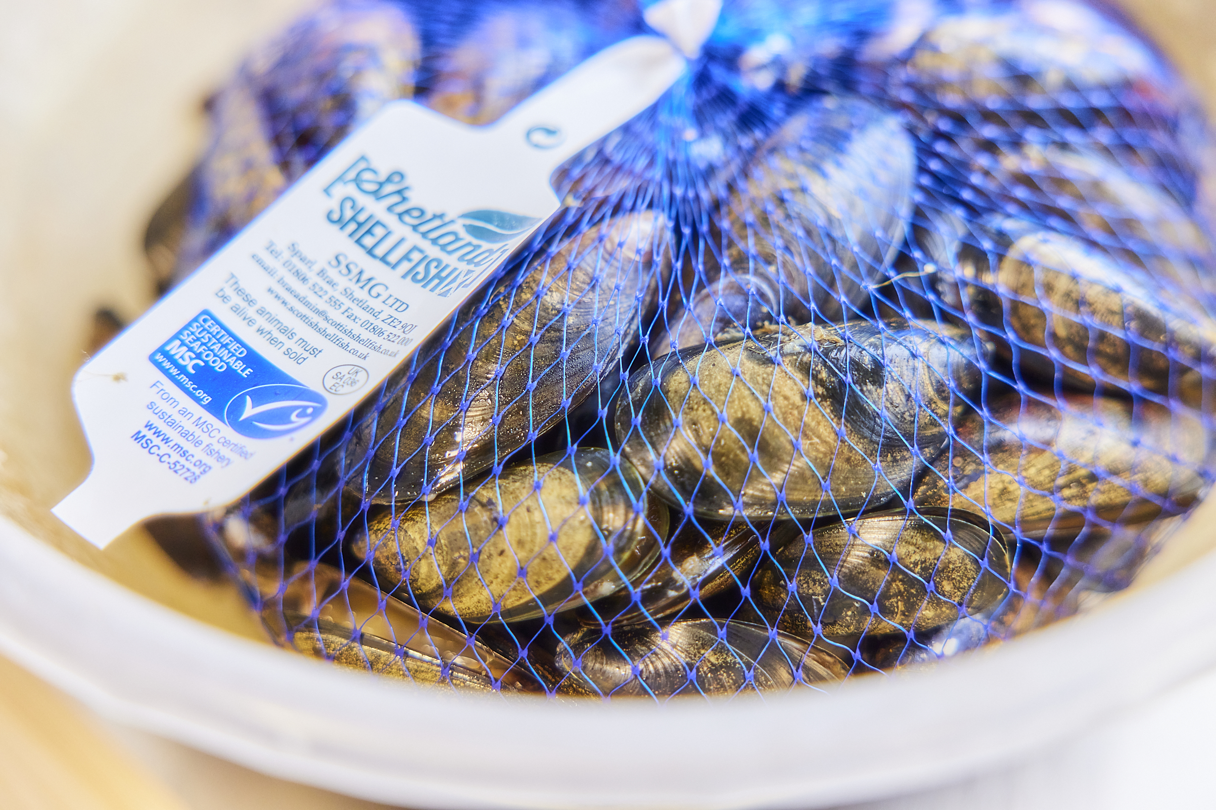 Net of mussels with label displaying MSC blue tick logo
