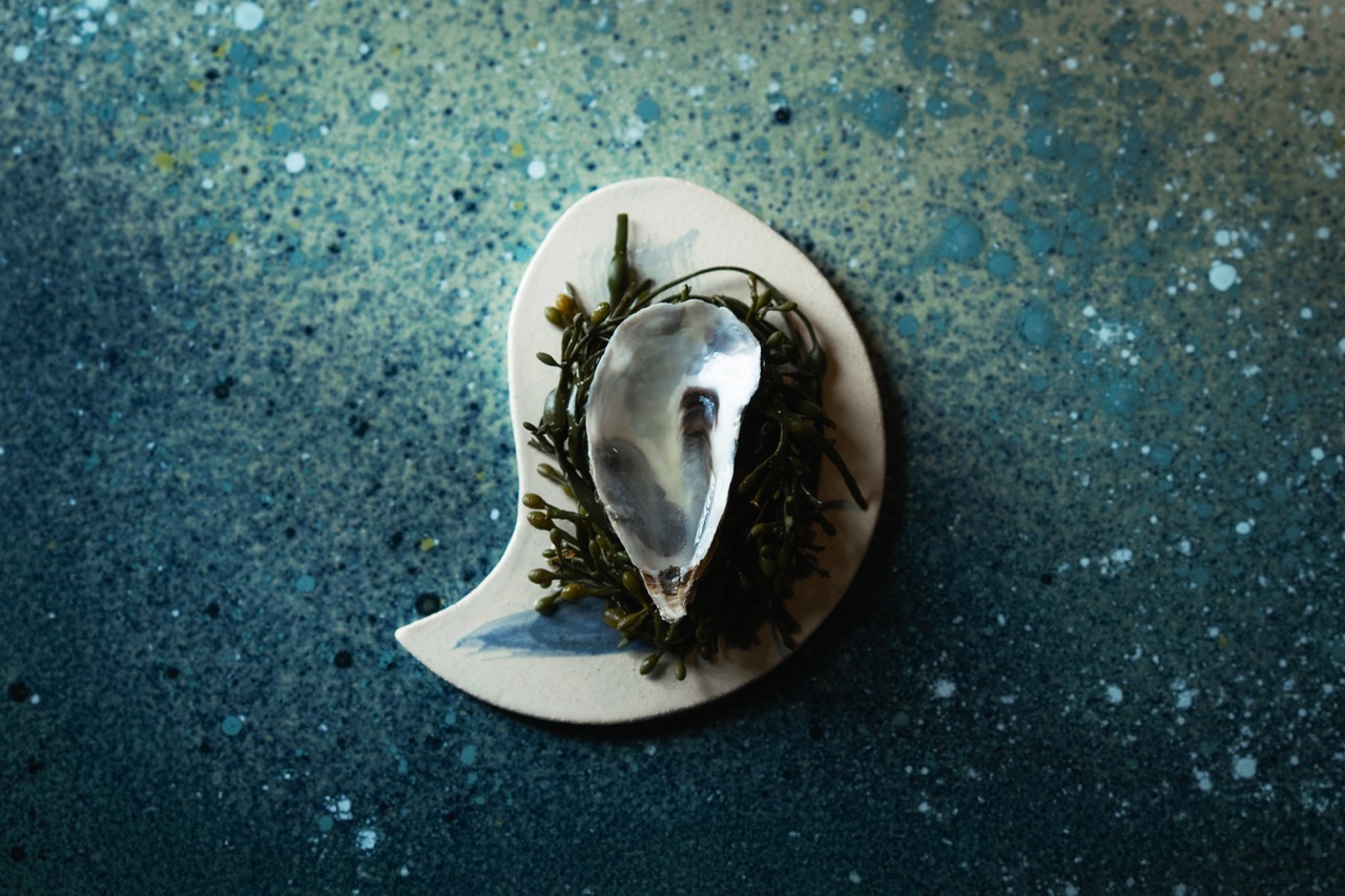 Overhead shot of a drink served in an oyster shell at De Vie bar, Paris
