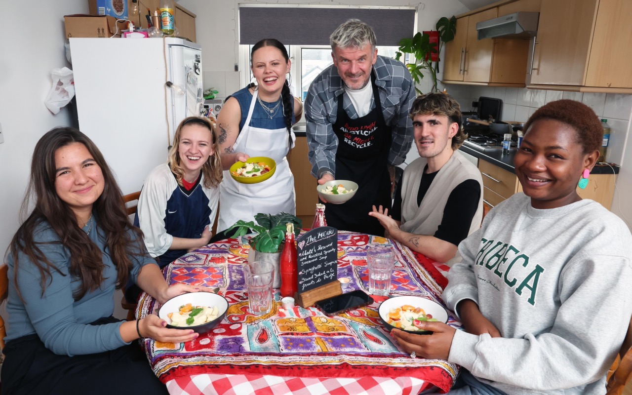 Cardiff Metropolitan University students around a kitchen table with Matt Pritchard