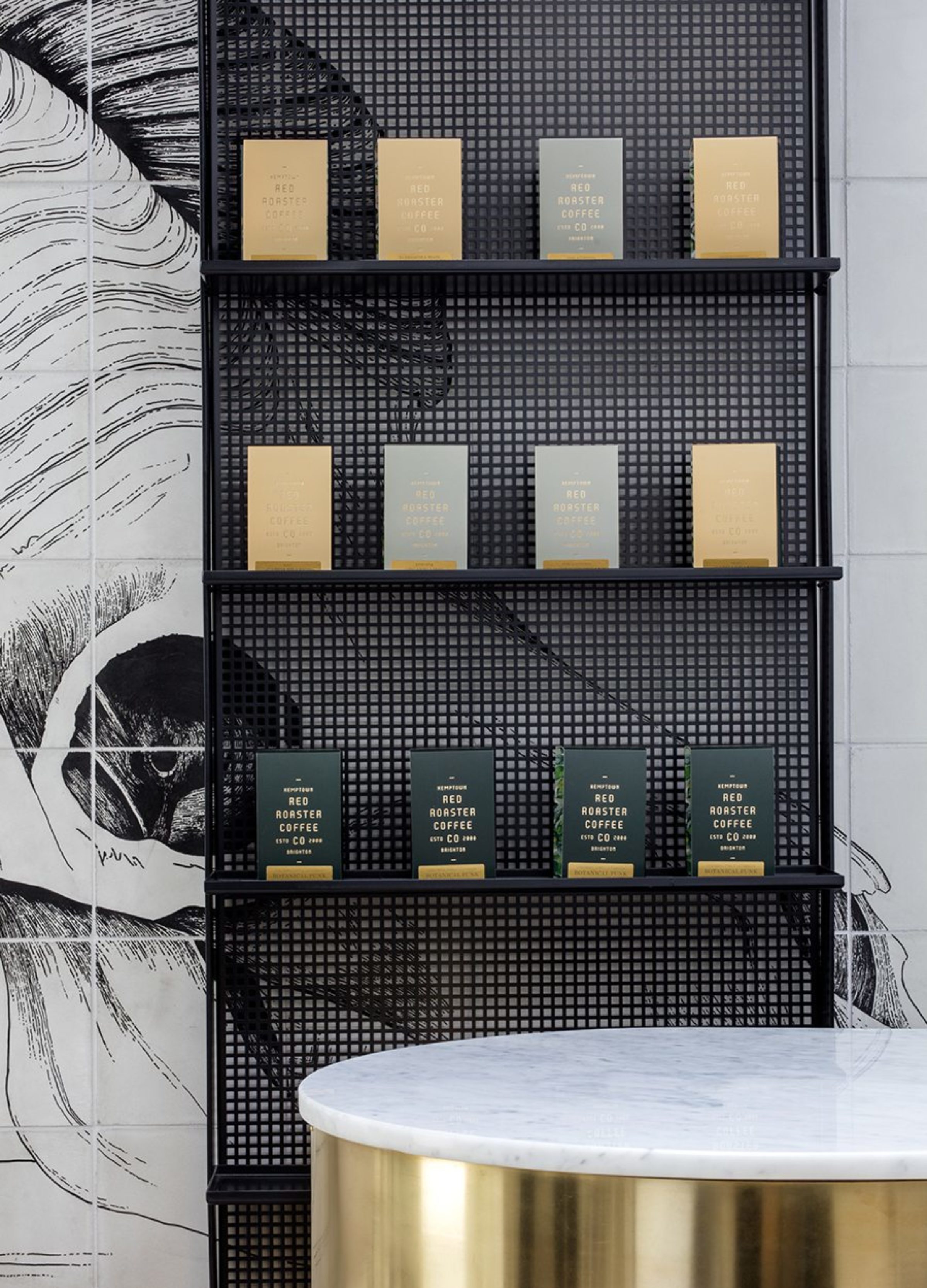 Boxes of Red Roaster coffee on black shelves