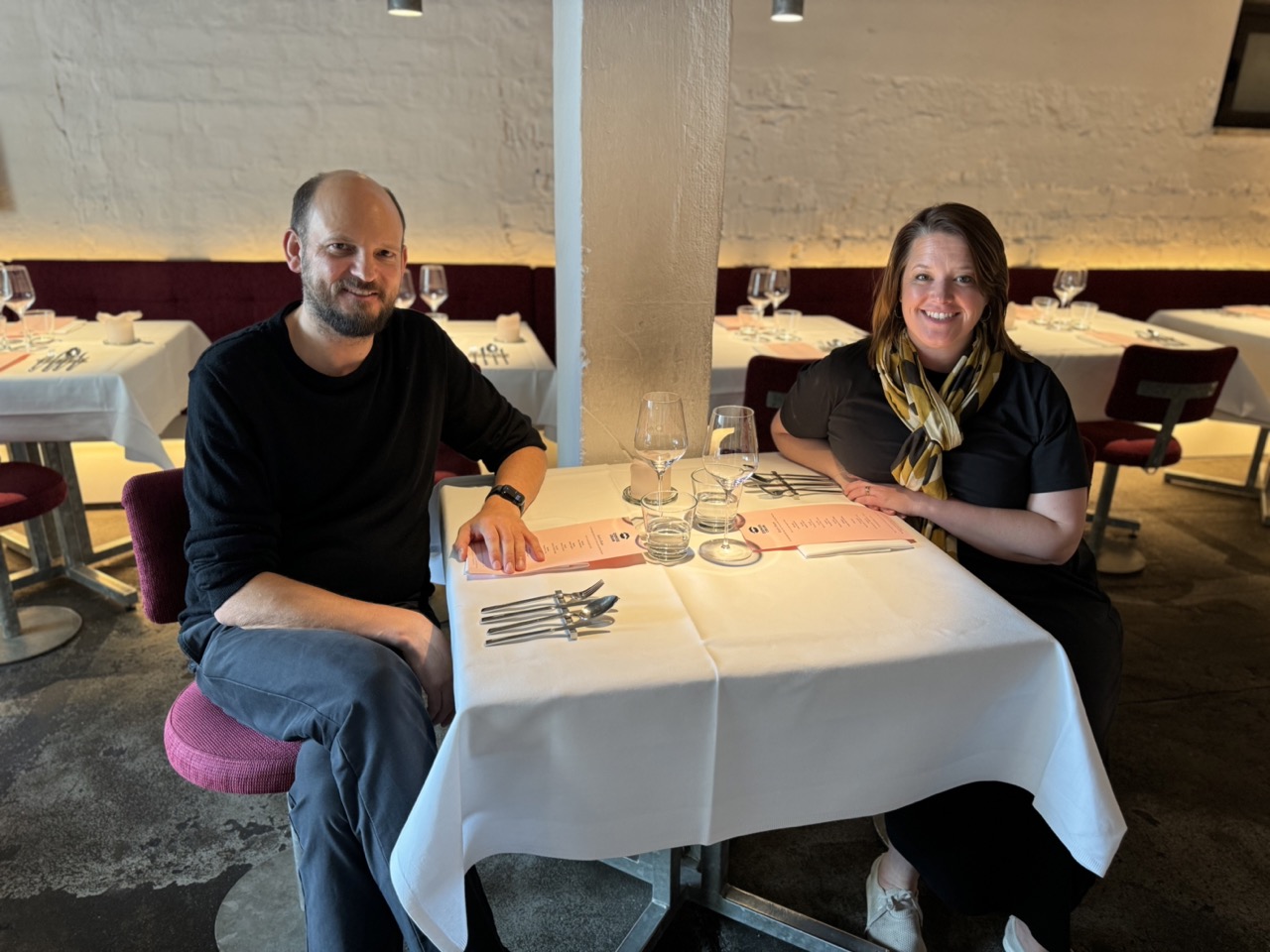 Cookie "Heinz" sitting at a restaurant table with Juliane Caillouette Noble