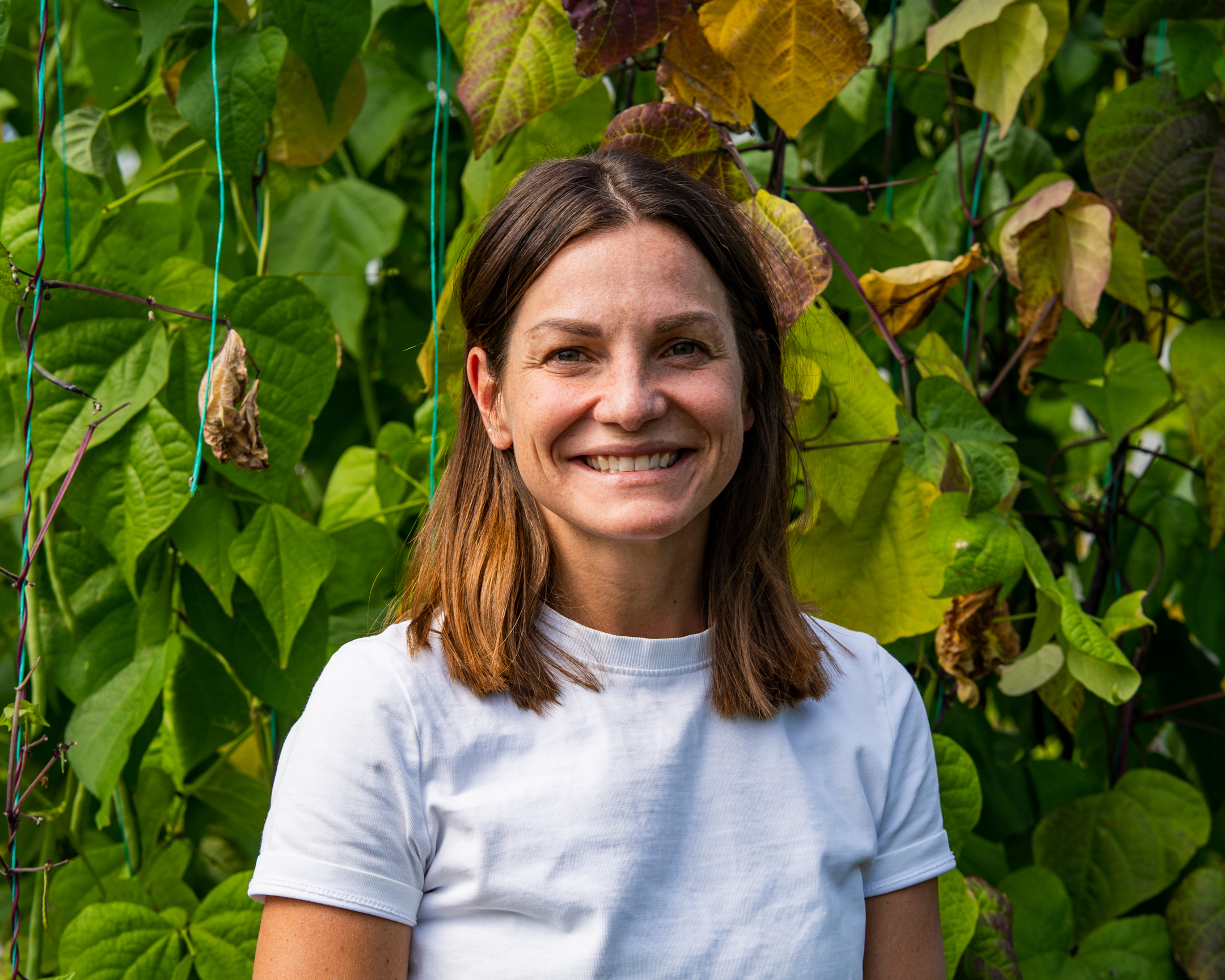 Martina Dell headshot against leafy background