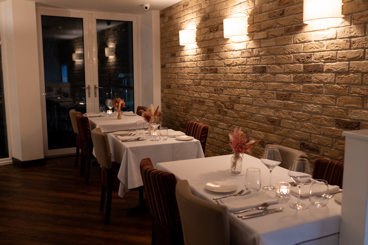Cosy interior shot of tables set at Lavang, soft lighting
